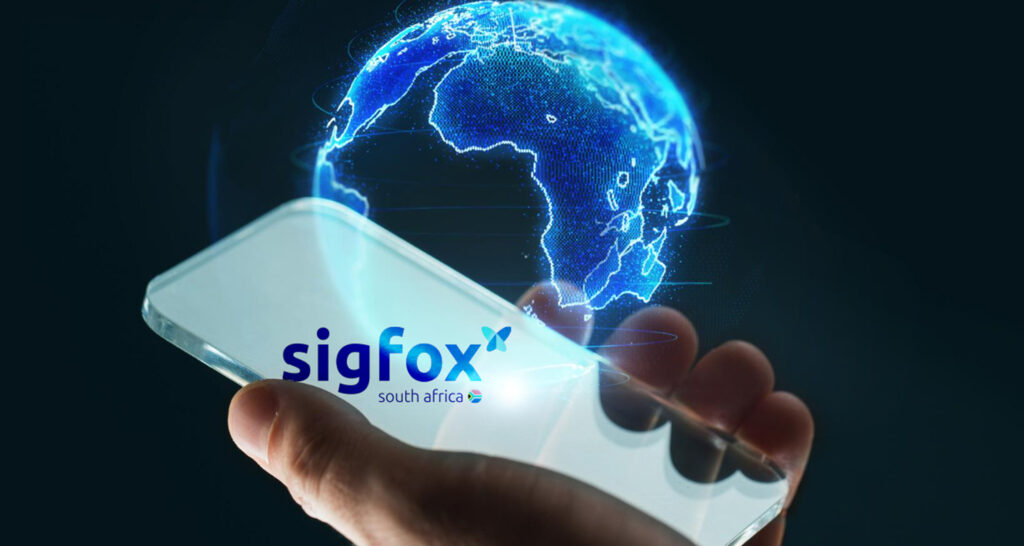 Holographic earth symbol showing the African continent, positioned beside a person’s hand holding a mobile phone with the Sigfox South Africa logo beside a south African flag.
